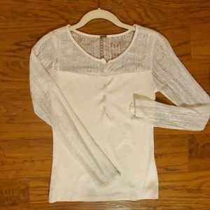 Cream colored top with laced sleeves